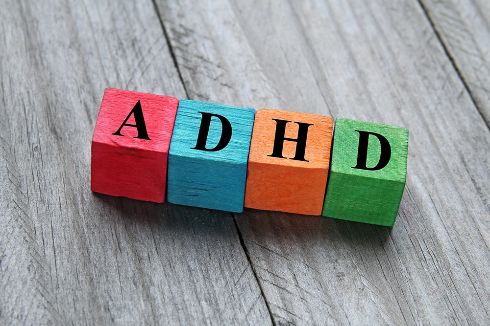 Red, blue, orange, and green blocks with the letters A, D, H, D, symbolizing ADHD and related coaching services.