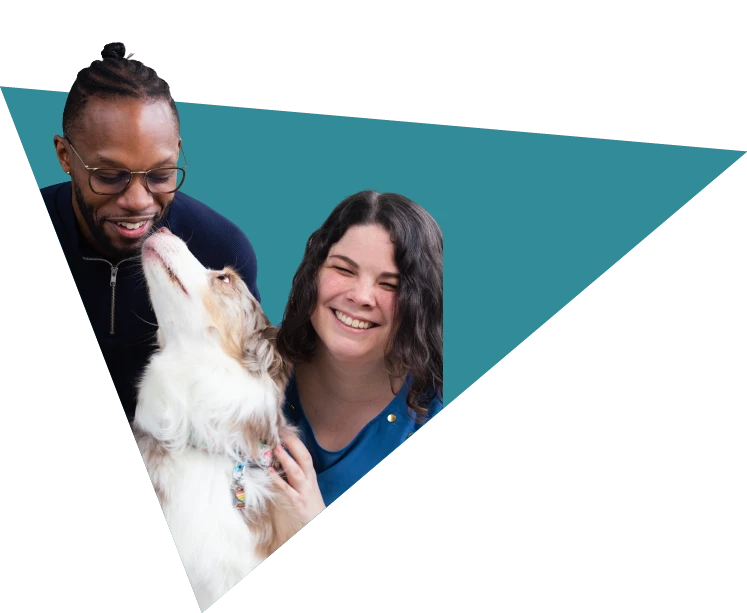 Shelby Mailho (Psy.D.) and Jerrod Handy-Robinson (Psy.d., MSCP) interacting with Whitley, the Collective Insight's therapy dog.