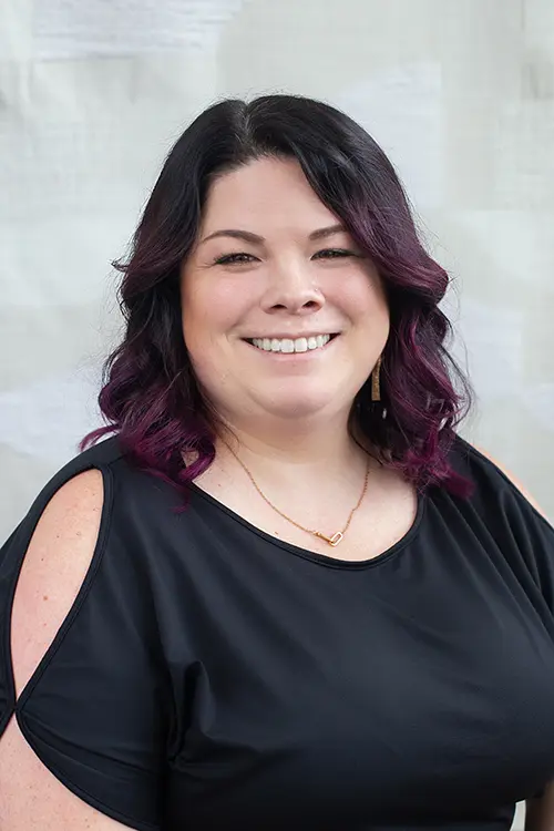 Professional headshot of Dr. Shelby Mailho, a clinical psychologist with expertise in working with queer, trans*, and neurodivergent individuals. She provides therapy, gender surgery letters, and psychological testing.